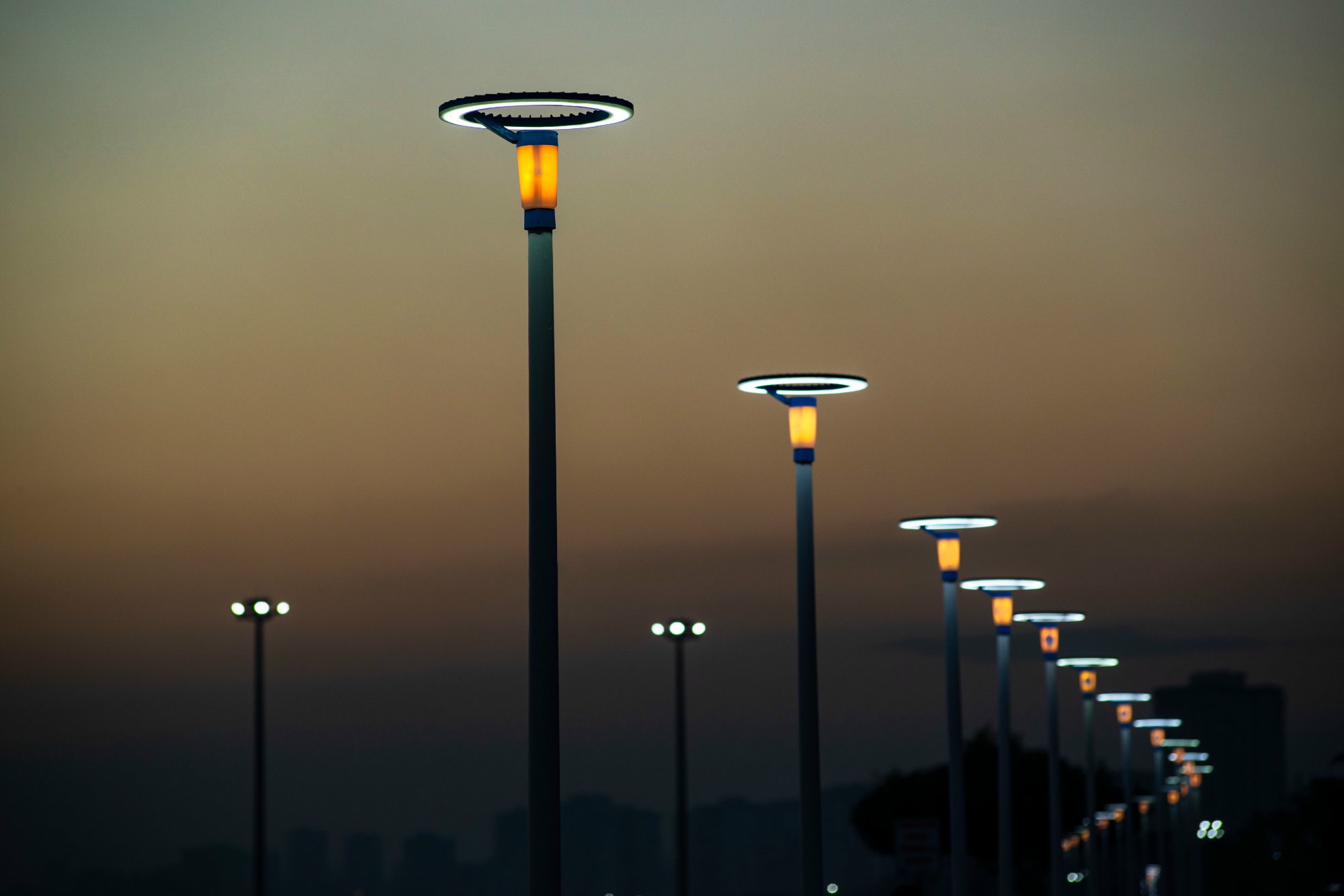 Garden and landscape lighting poles at dusk — decorative post-top luminaires