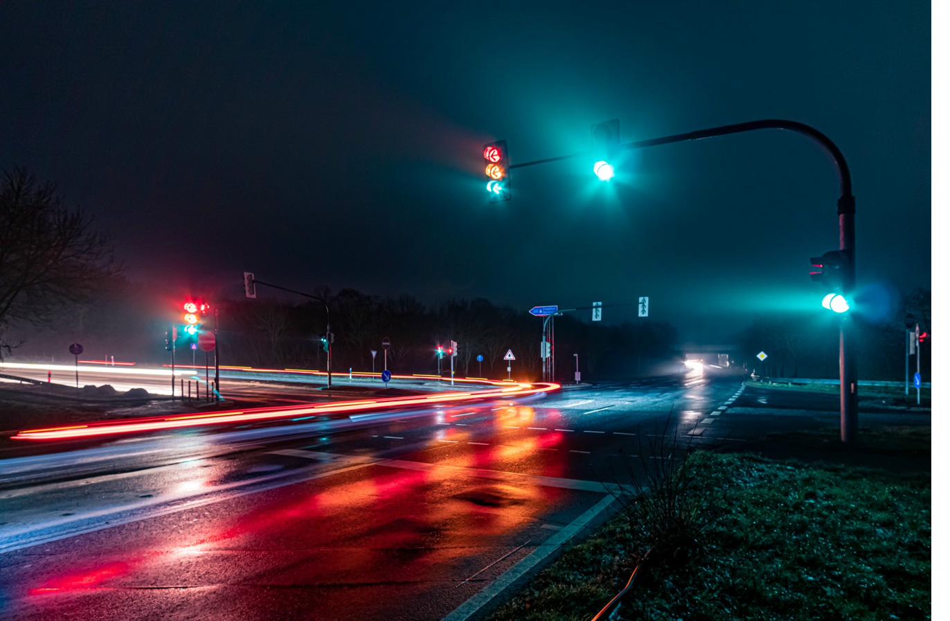 Traffic signal poles at night — cantilever mast-arm road junction UAE approved